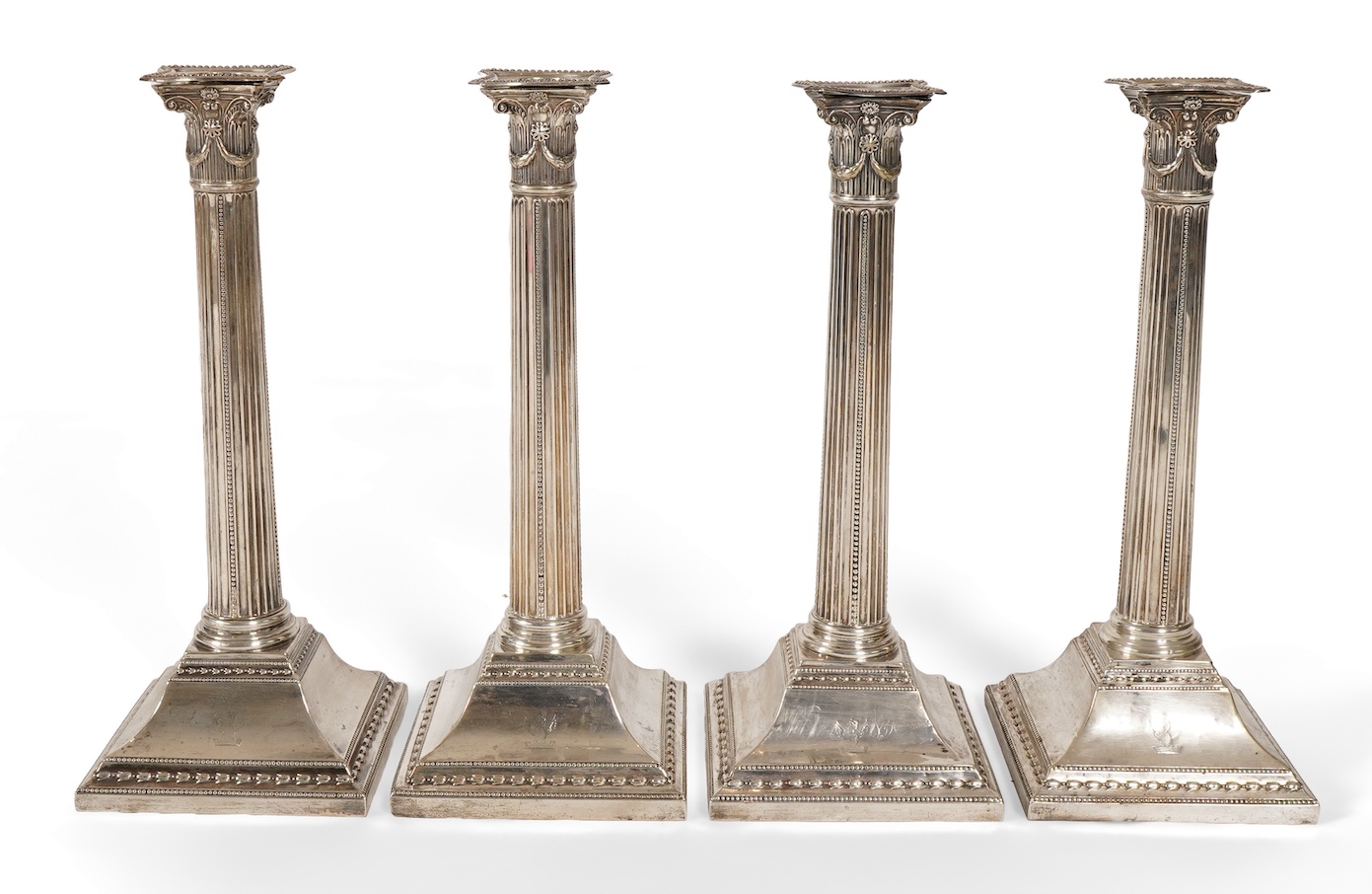 A set of four George III silver corinthian column candlesticks, by John Winter & Co